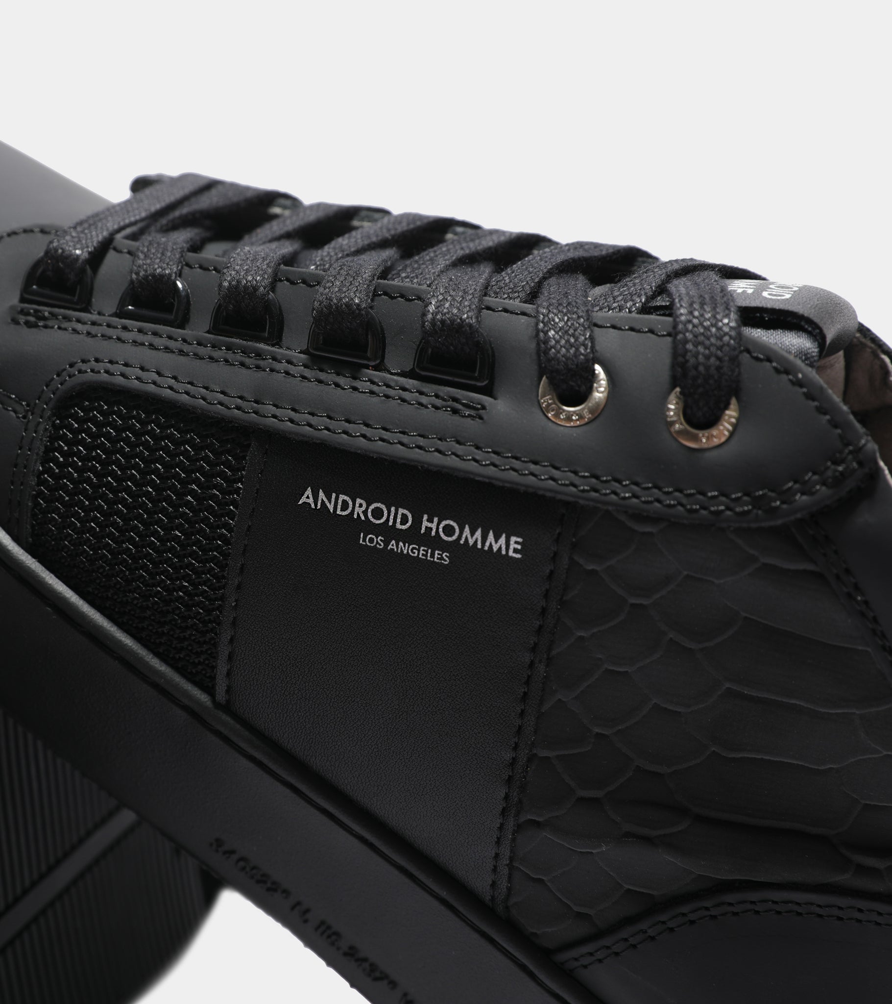 Ecom imagery of the Propulsion Mid Black Gomma Reflective Python Android Homme Trainers.
