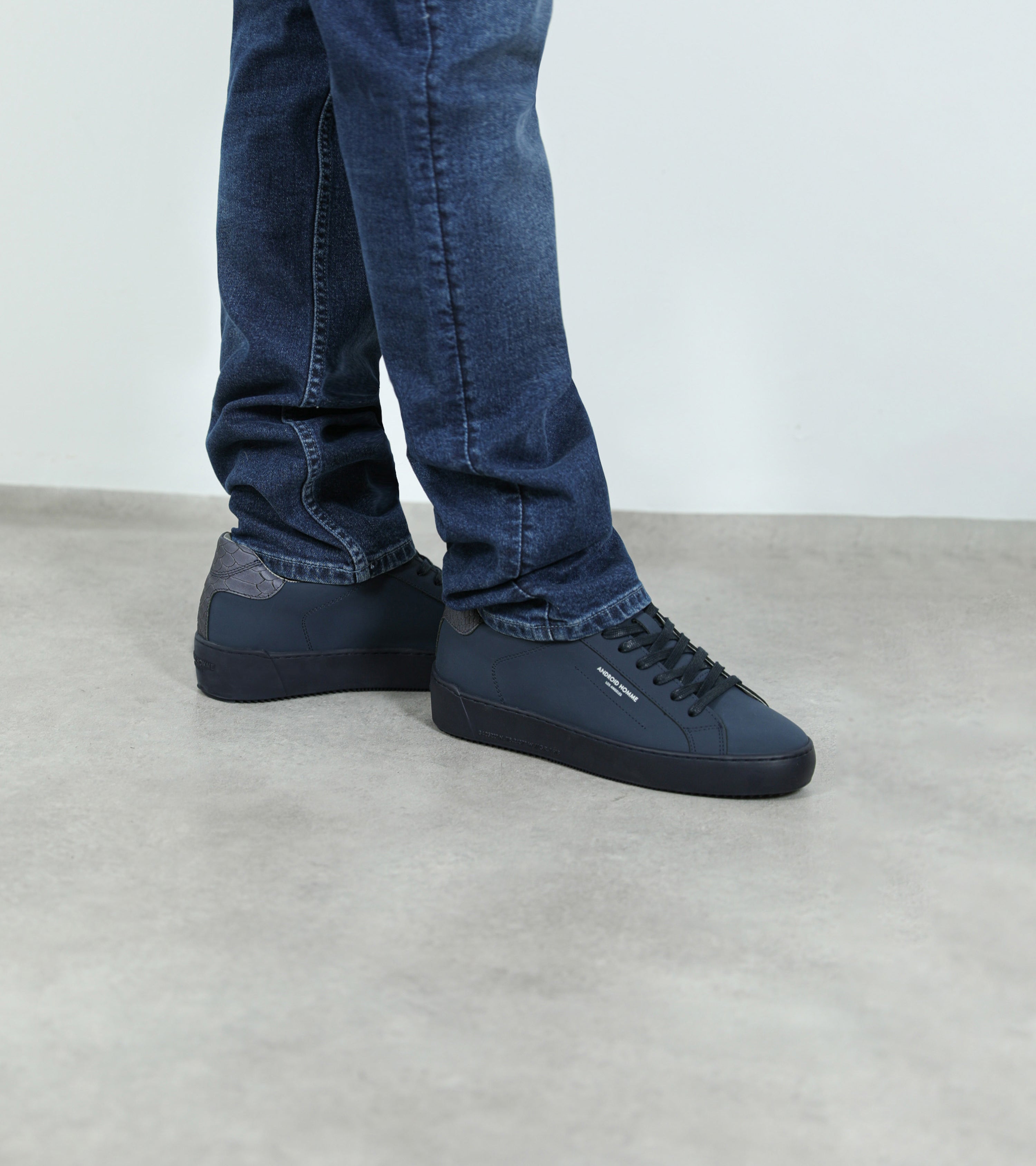 Ecom imagery of the Zuma Navy Gomma Reflective Python Android Homme Trainers on foot.