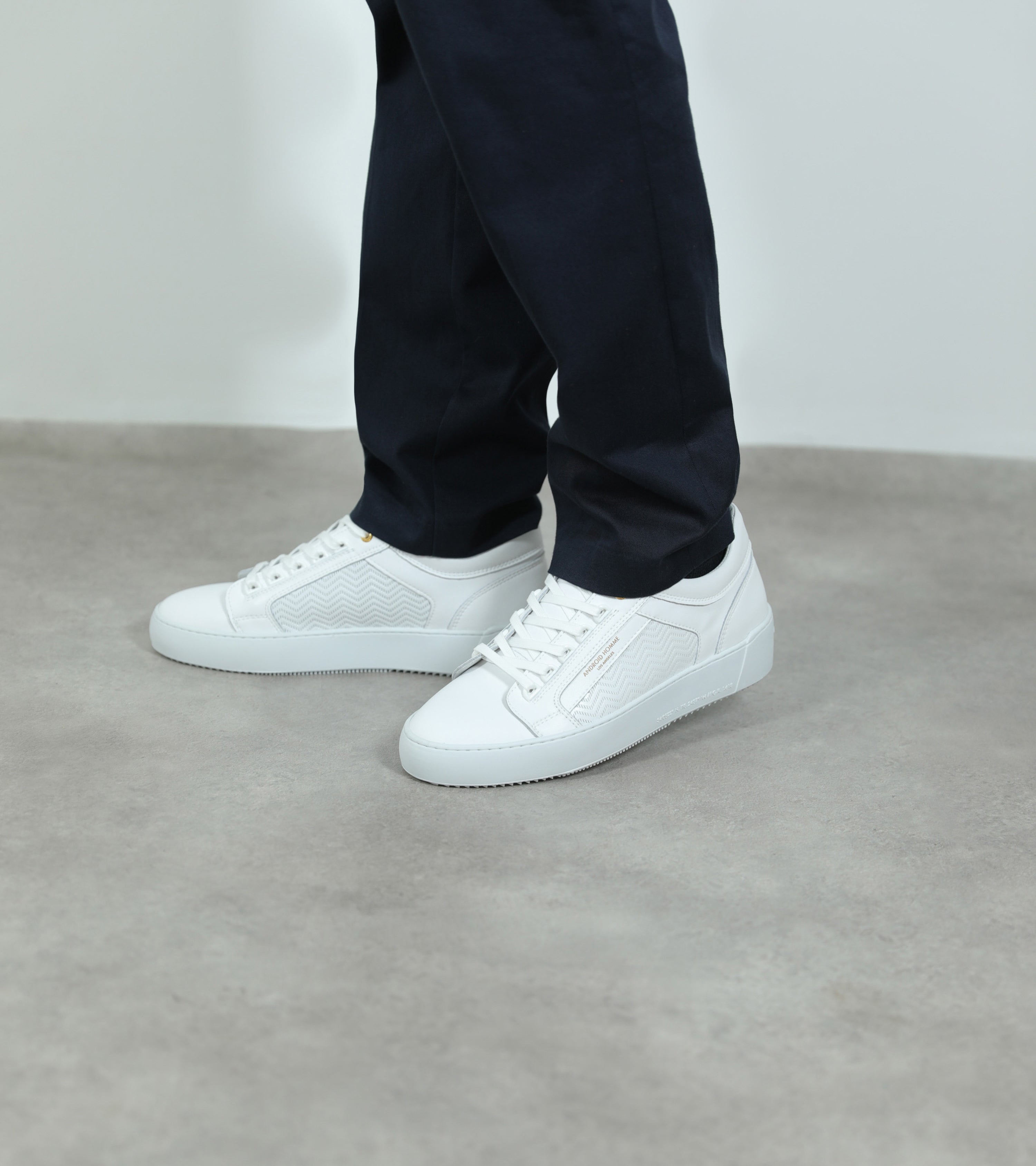 Ecom imagery of the Venice White Emboss Leather Android Homme Trainers on foot.