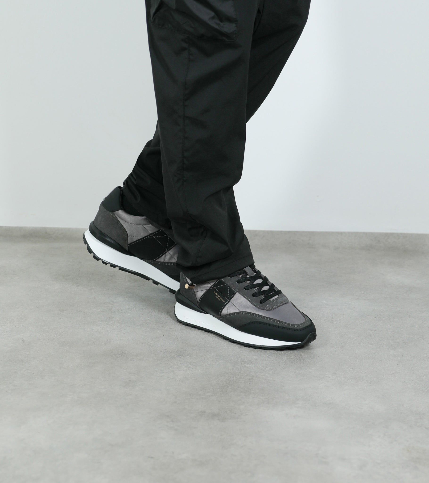 Ecom imagery of the Marina Del Rey Grey Nylon Black Suede Android Homme Trainers on foot.