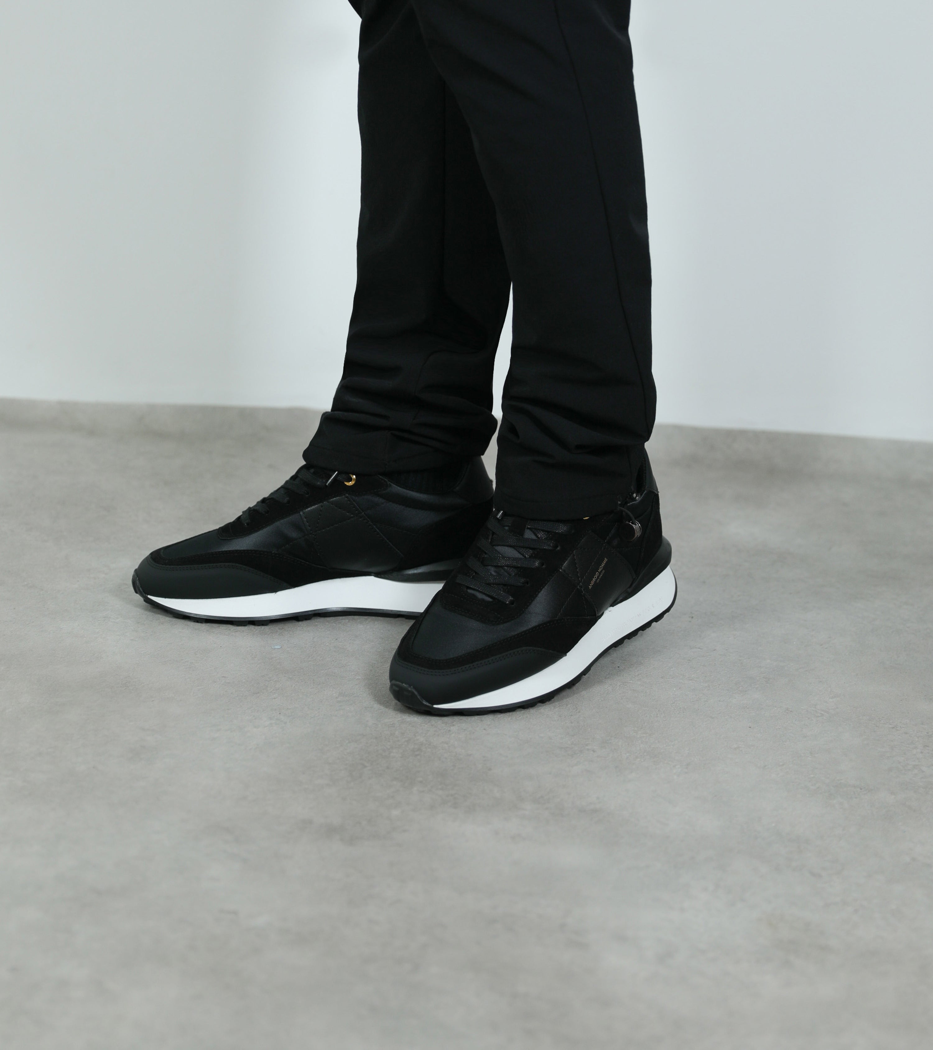 Ecom imagery of the Marina Del Rey Black Nylon Black Suede Android Homme Trainers on foot.