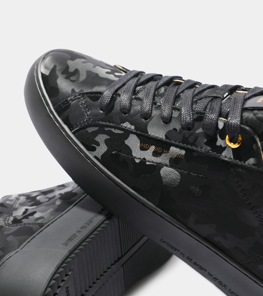 Detailed ecom imagery of the Zuma All Over Black Leather Camo Android Homme Trainers.